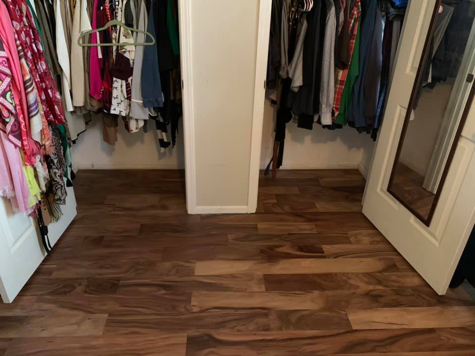 Hardwood flooring in walk-in closet with custom organization