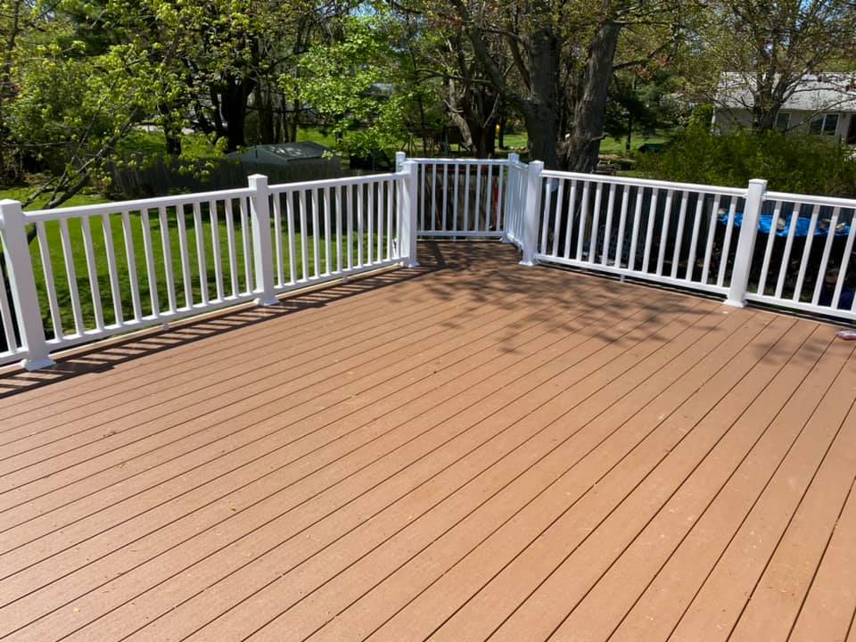 Beautiful deck construction with wood planks and white railings