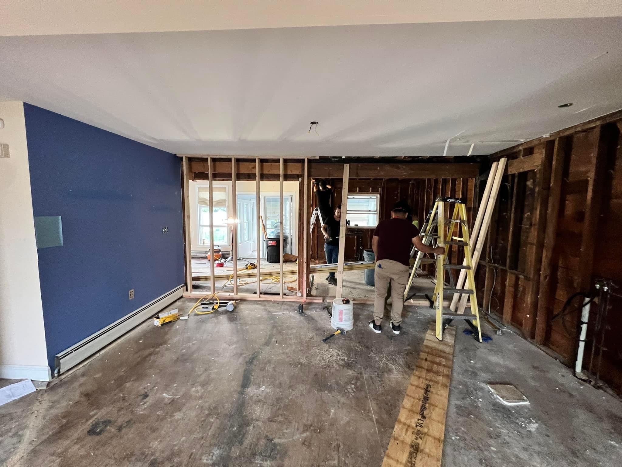 Home renovation project showing wall removal and open concept construction