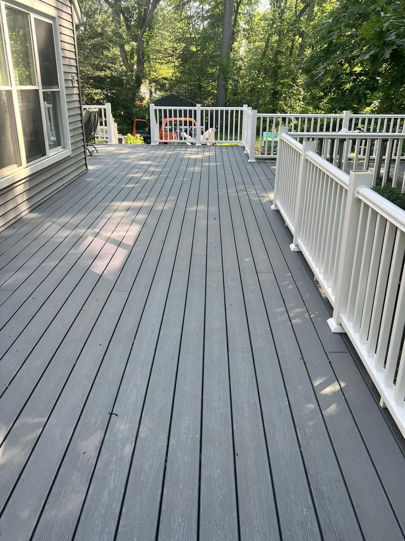 Large composite deck with white railings for outdoor entertaining
