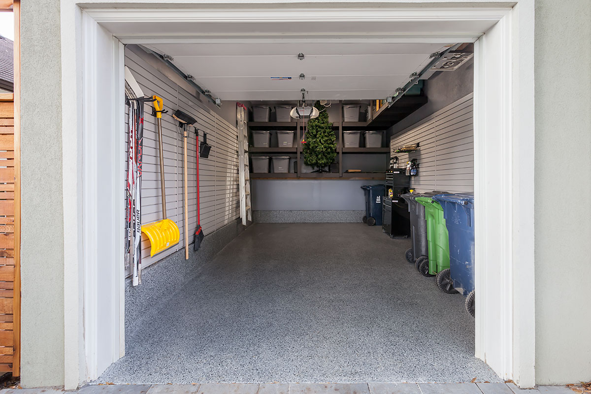 Organized garage with wall storage systems and efficient floor layout
