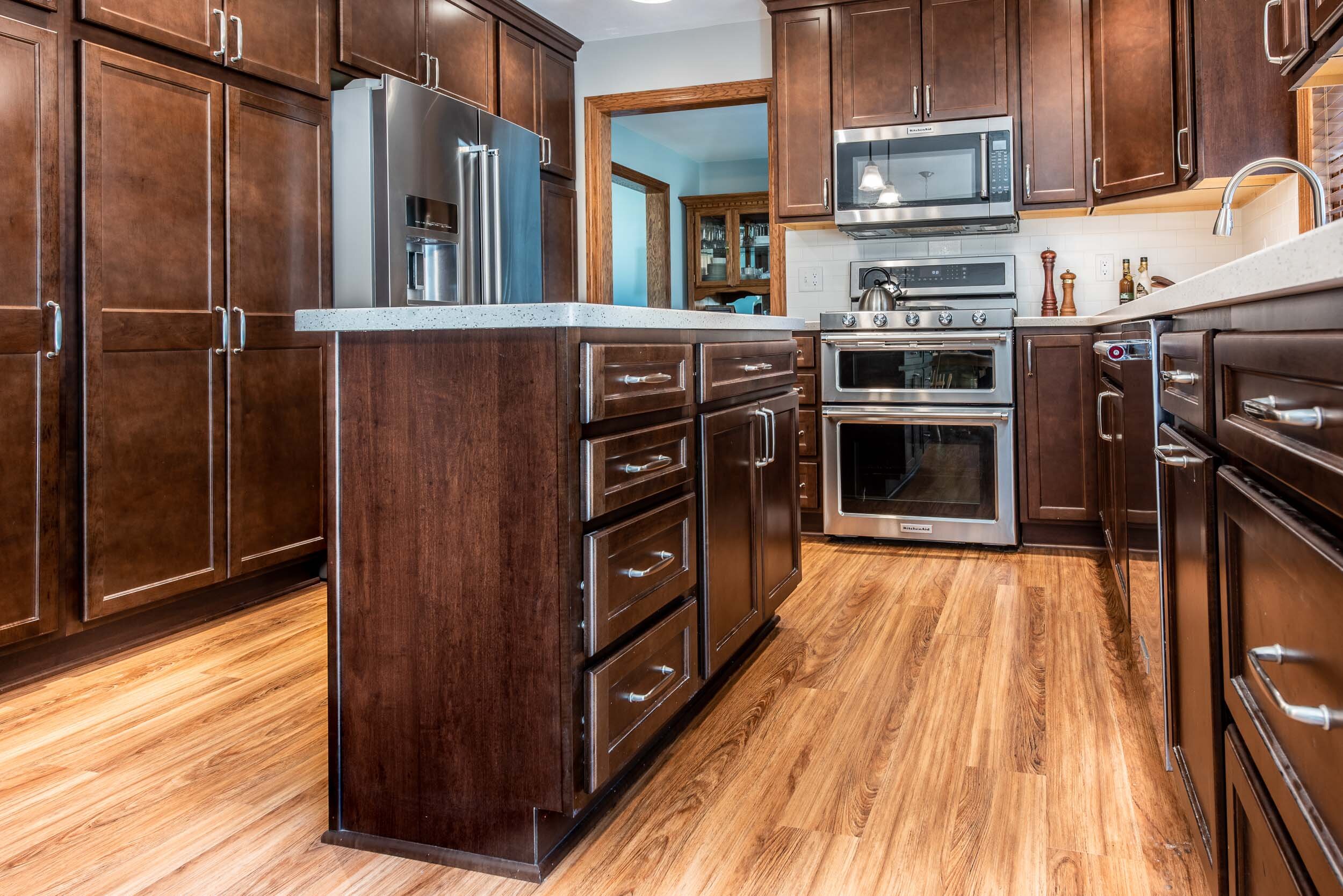 Professional kitchen with beautiful hardwood flooring and custom cabinetry