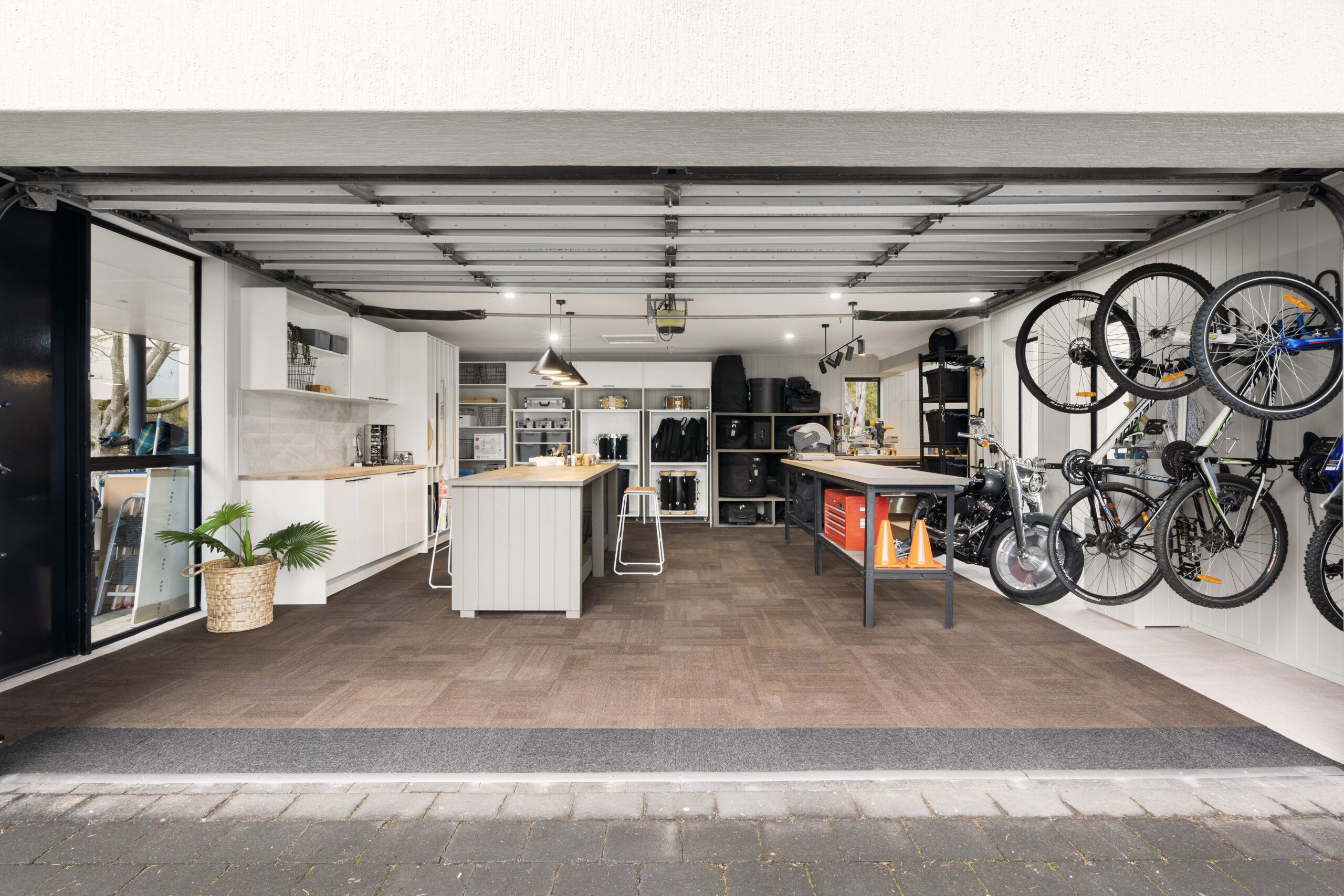 Modern garage organization with bike storage, cabinets, and functional workspace