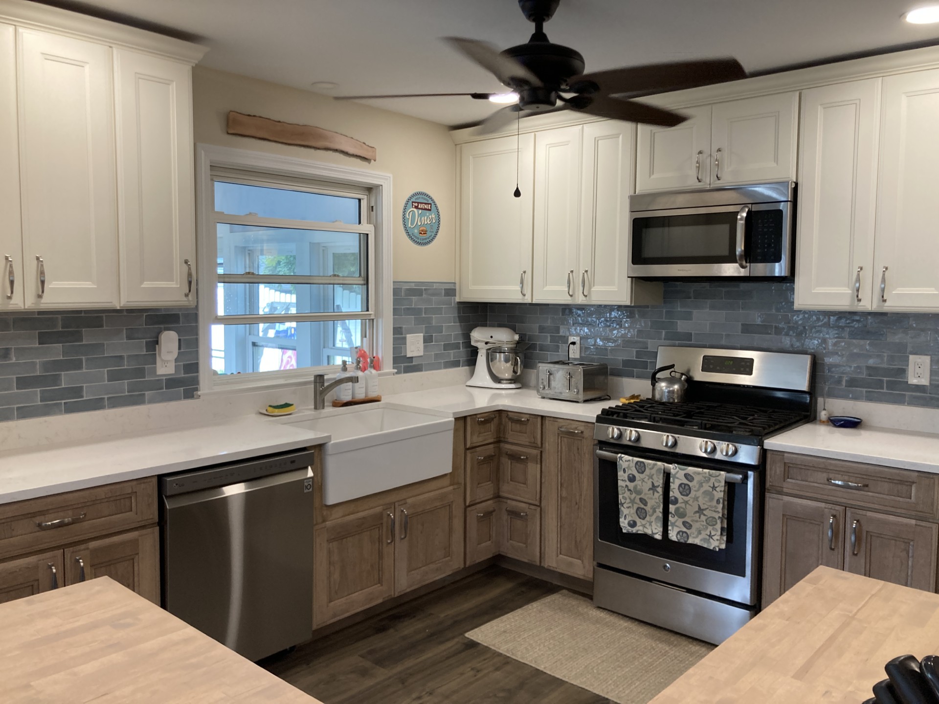 Elegant kitchen featuring white cabinetry, subway tile backsplash, and farmhouse sink